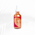 Aura Shimmering Dry Body Oil in a glass dropper bottle, featuring a warm bronze hue, perfect for summer-inspired skin glow.